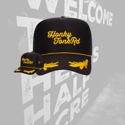 Black cap with yellow text and graphics on a gray background
